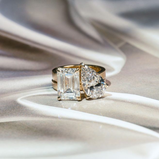 a 2 piece toi et moi engagement ring, made of 1 pear lab diamond band and 1 emerald lab diamond band fitting together like a puzzle.