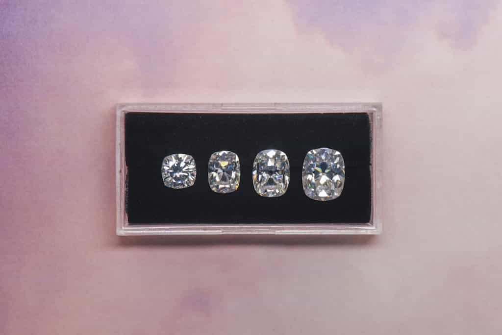 4 cushion moissanites of different sizes