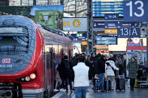 (FILES) Passengers enter a regional train at the main railway station in Frankfurt am Main, western Germany, as German train drivers stage a strike, on January 28, 2024.