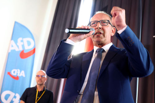 Top candidate of the far-right Alternative for Germany (AfD) party for regional elections in Saxony Joerg Urban (R) speaks on stage during the party's election night in Dresden, eastern Germany, on September 1, 2024, during Saxony's regional elections day.