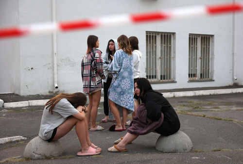 Students of the International Academy of Personnel Management watch emergency teams work to extinguishing a fire in one buildings of their educational institution after a missile attack in Kyiv on September 2, 2024, amid the Russian invasion in Ukraine.