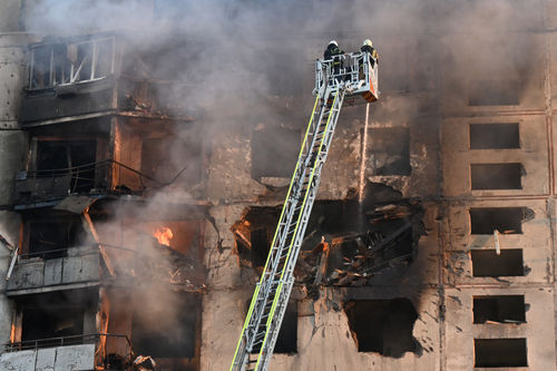 Ukrainian rescuers work to extinguish a fire in a residential building following a missile attack in Kharkiv on September 15, 2024, amid the Russian invasion of Ukraine.