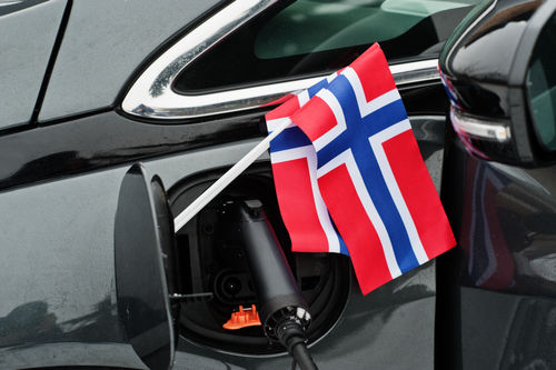 Ein Elektroauto in Norwegen mit Flagge von Norwegen.