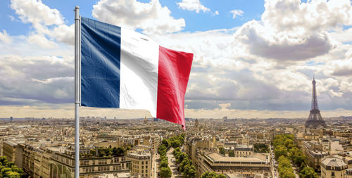 Die Flagge von Frankreich mit Paris und dem Eiffelturm im Hintergrund