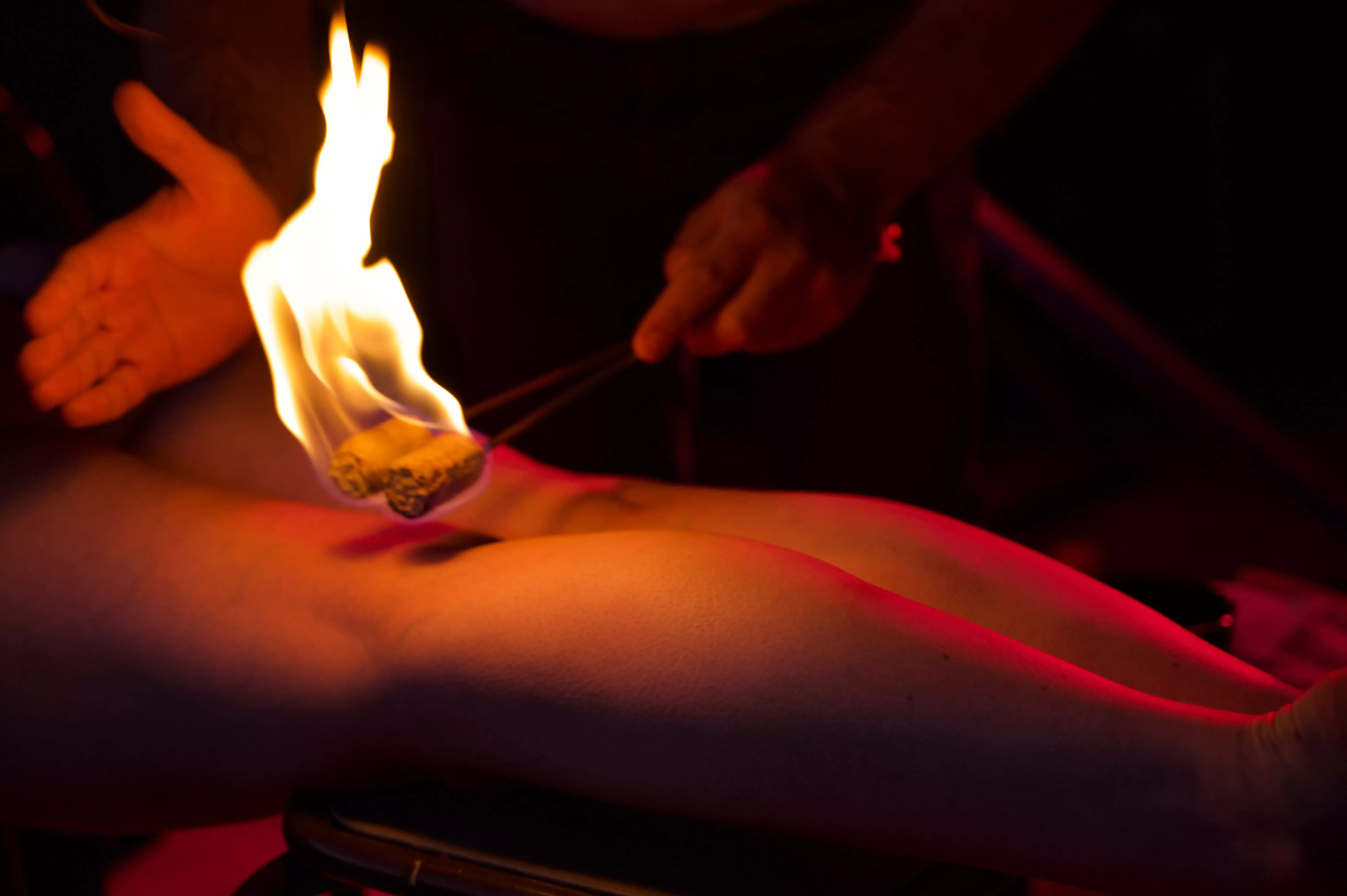 Trainer demonstrating fire massage techniques - photo by Olivierdelanuit