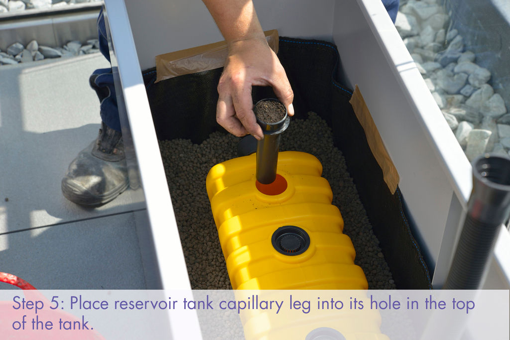 Commercial planter installation: place reservoir tank capillary leg into hole