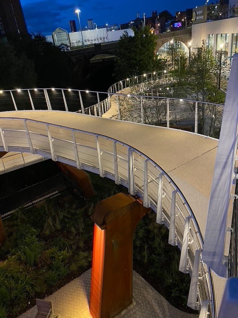 Illuminated handrails with LED Spotlight Luminaires on raised walkway