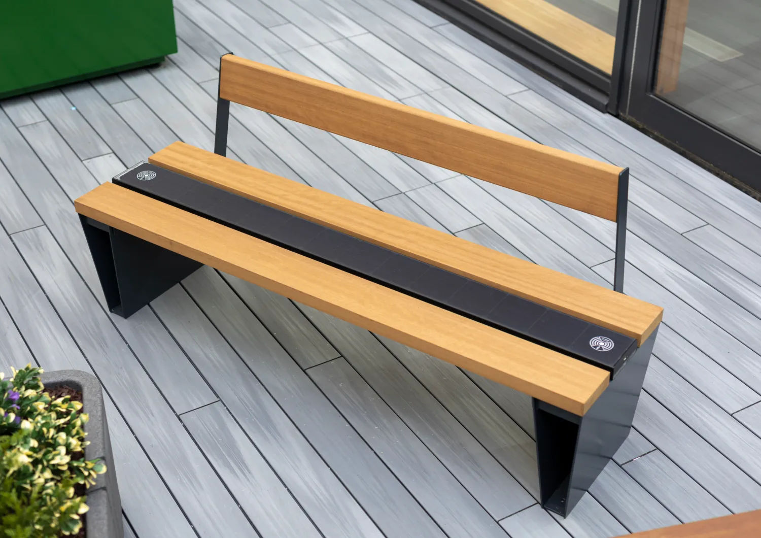 Veeva Sol bench from Furnitubes has a solar panel instead of a middle slat that powers a wireless mobile charger, a USB port and ambient light