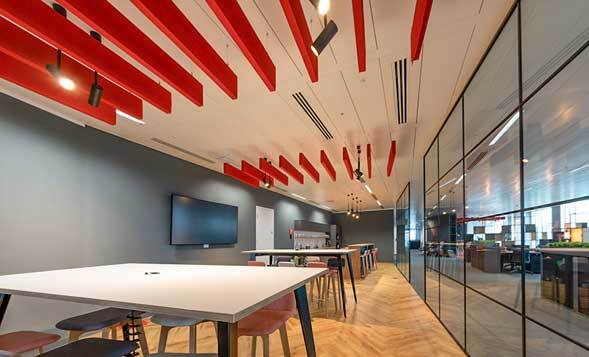 Acoustic baffles are hung from ceilings to absorb sounds and reduce reverberation and echoes