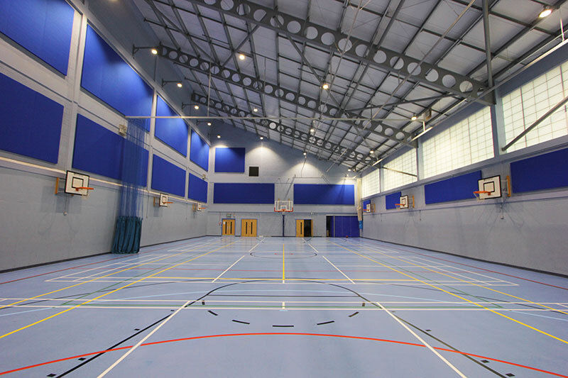 Blue acoustic wall panels in a sports hall