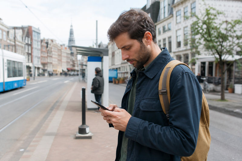 Traveler using mobile data on a smartphone abroad.