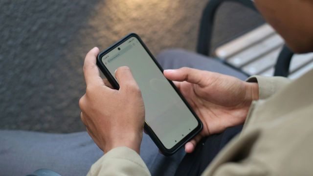 Traveler using unlimited data eSIM on smartphone