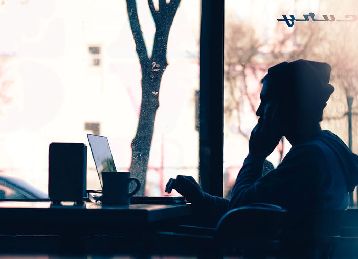 Silhouette woman and laptop