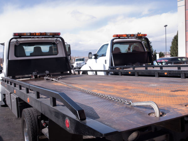 Two tow trucks side by side