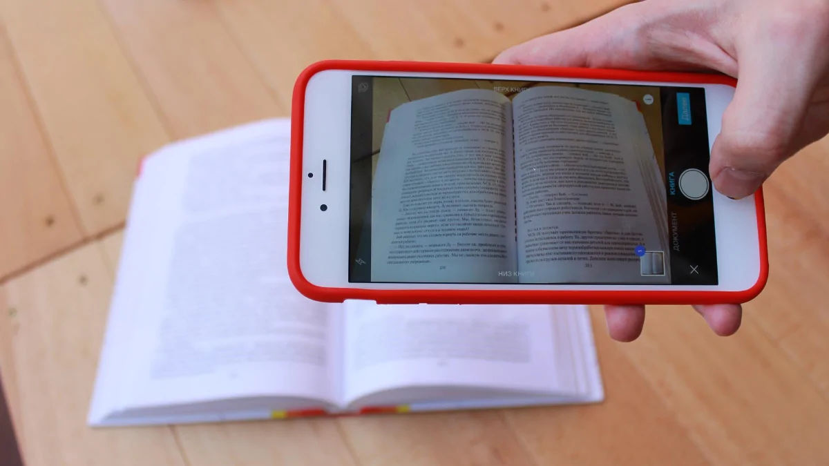 Celular digitalizando conteúdo do livro