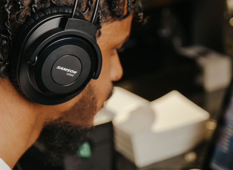 Male wearing SR880 headphones in a studio