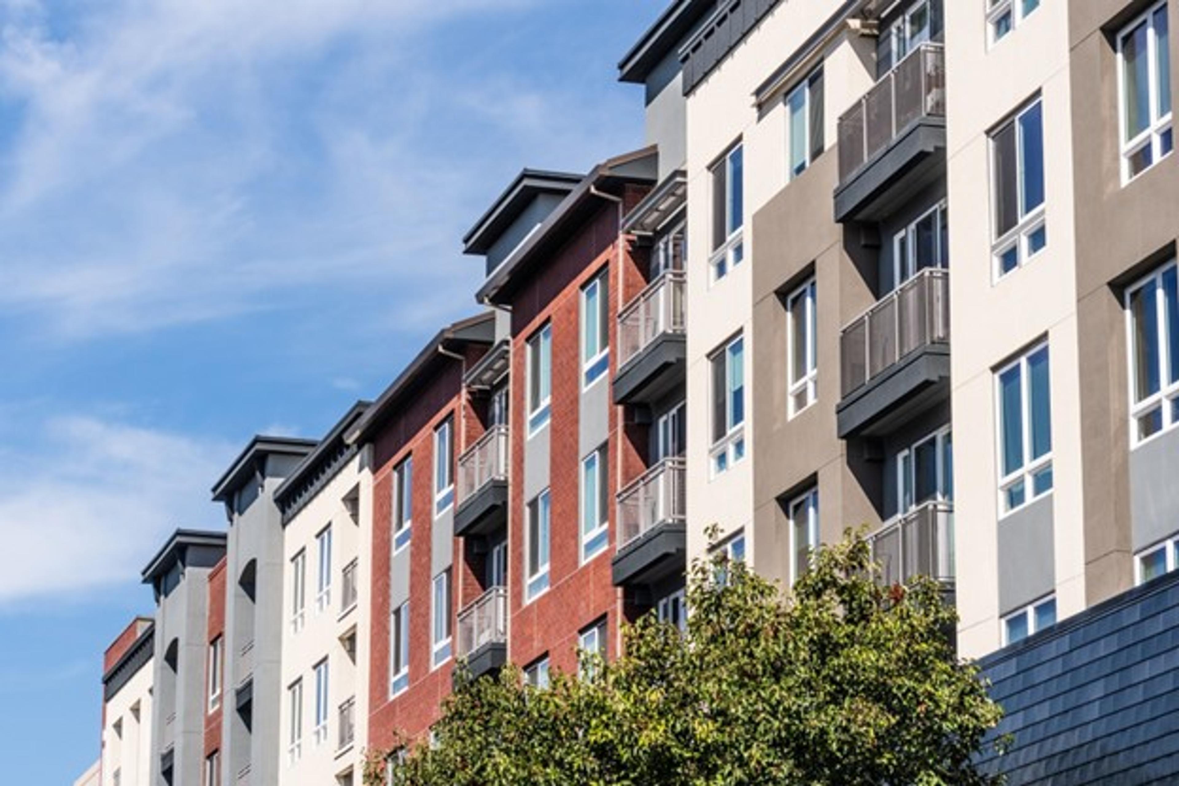Cropped street view looking up at an apartment or condo complex