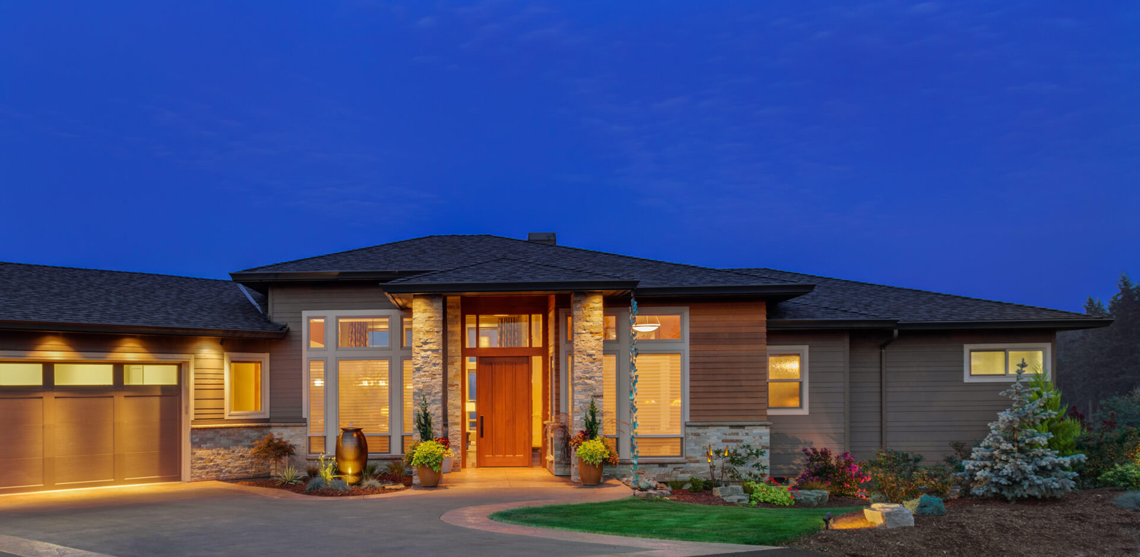Well-lit home in the evening with great curb appeal
