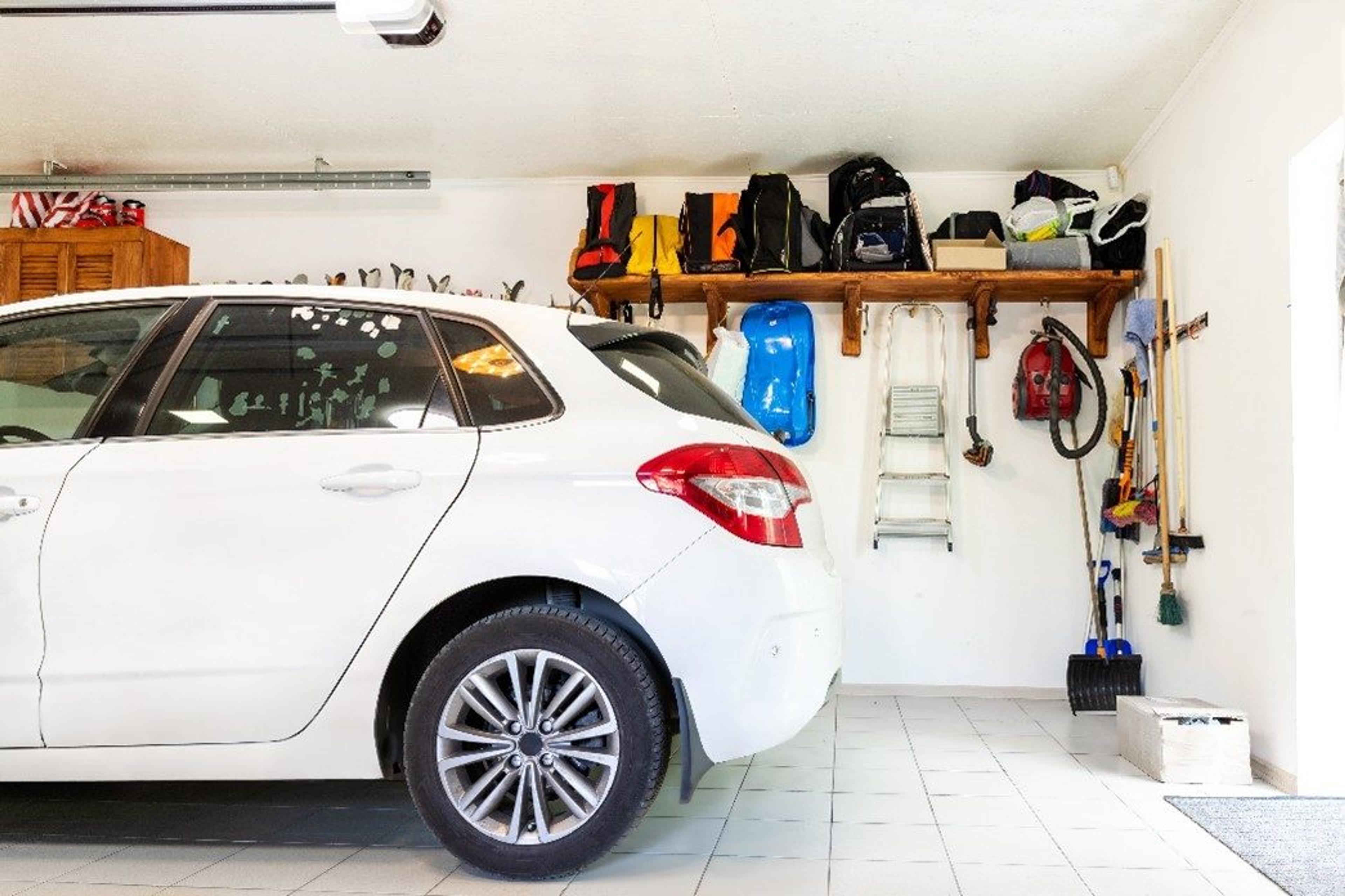 Car parked inside an organized garage