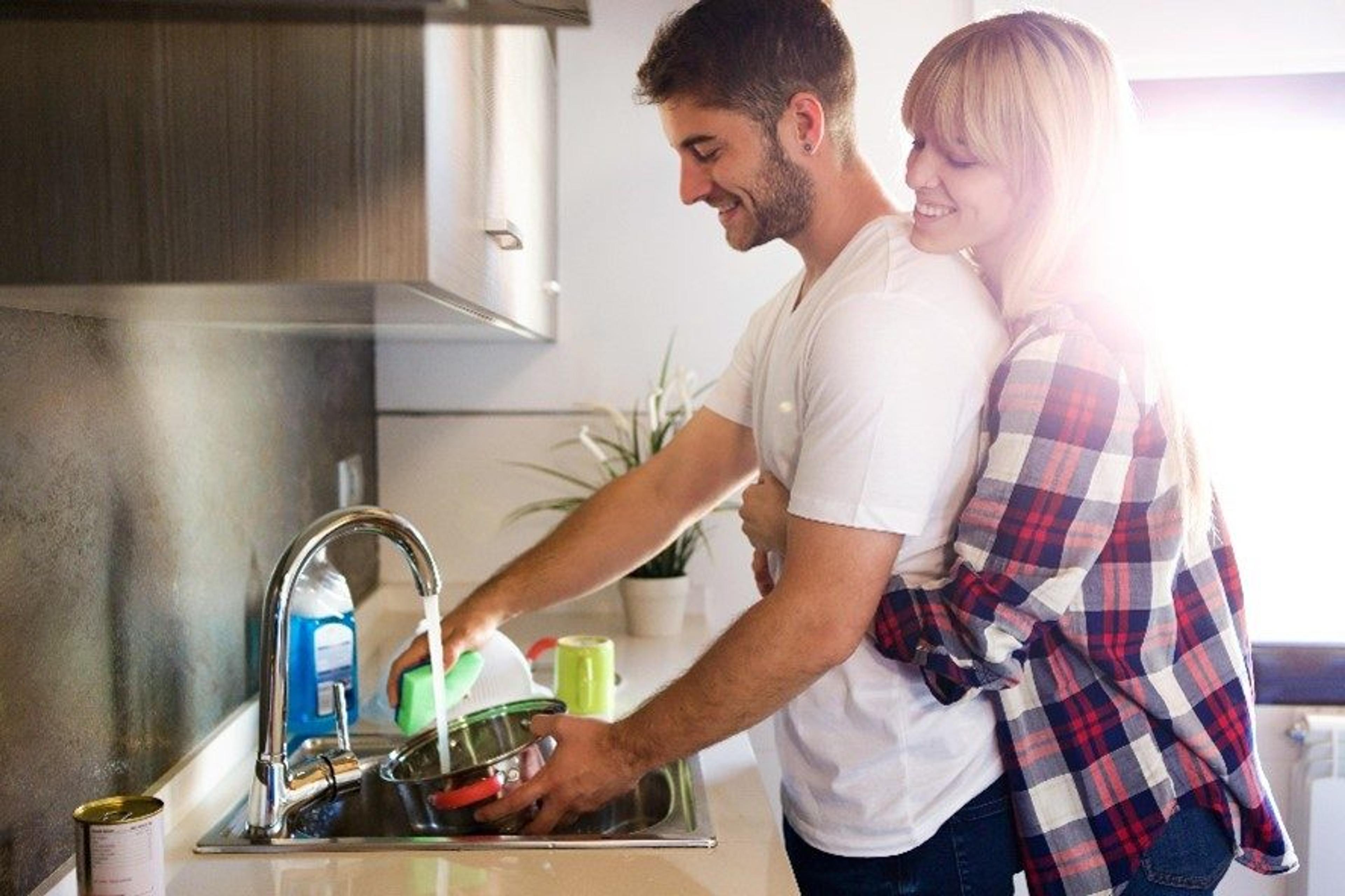 Couple washing dishes together