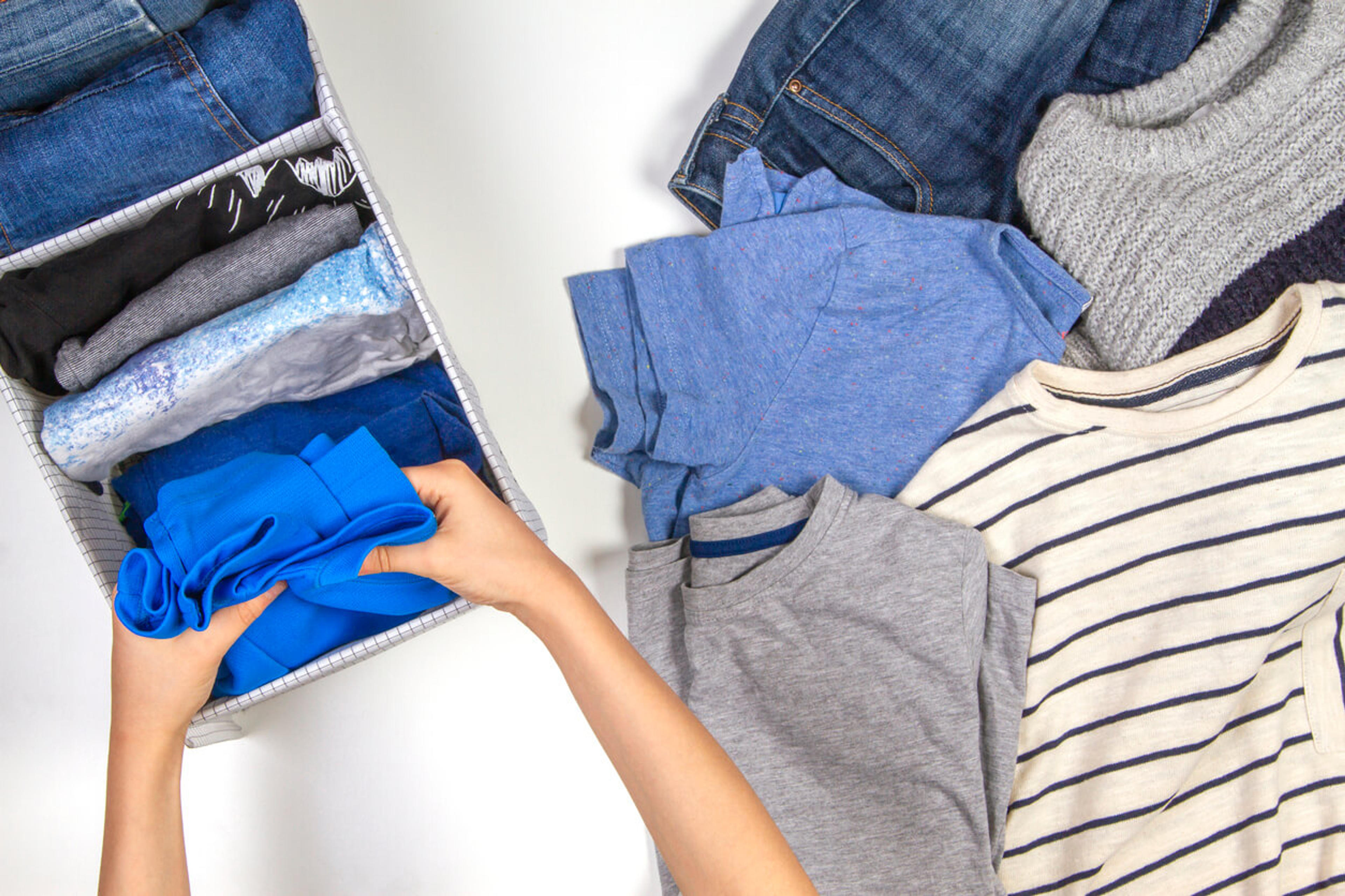 Placing folded clothing into fabric bins