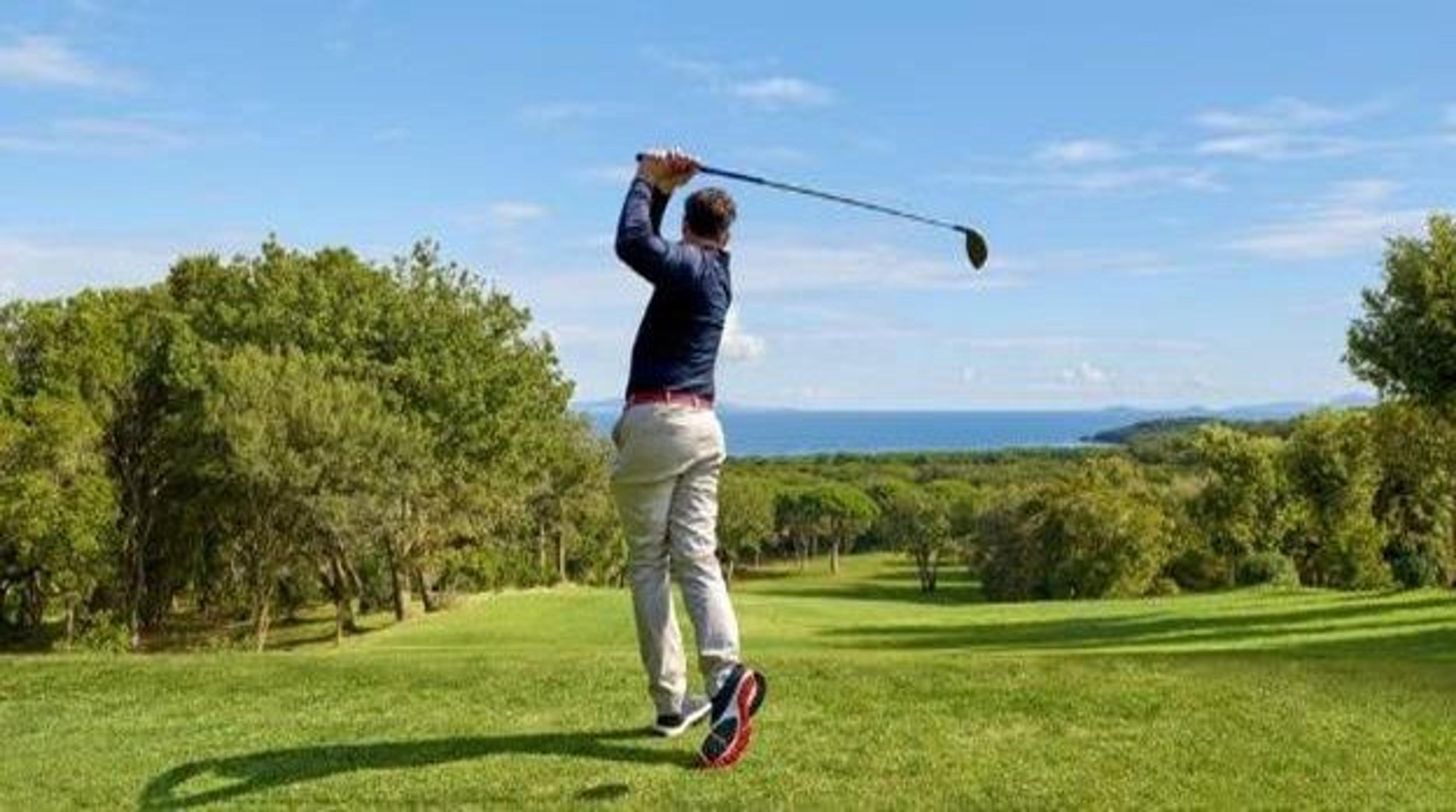 A man golfing at a golf course