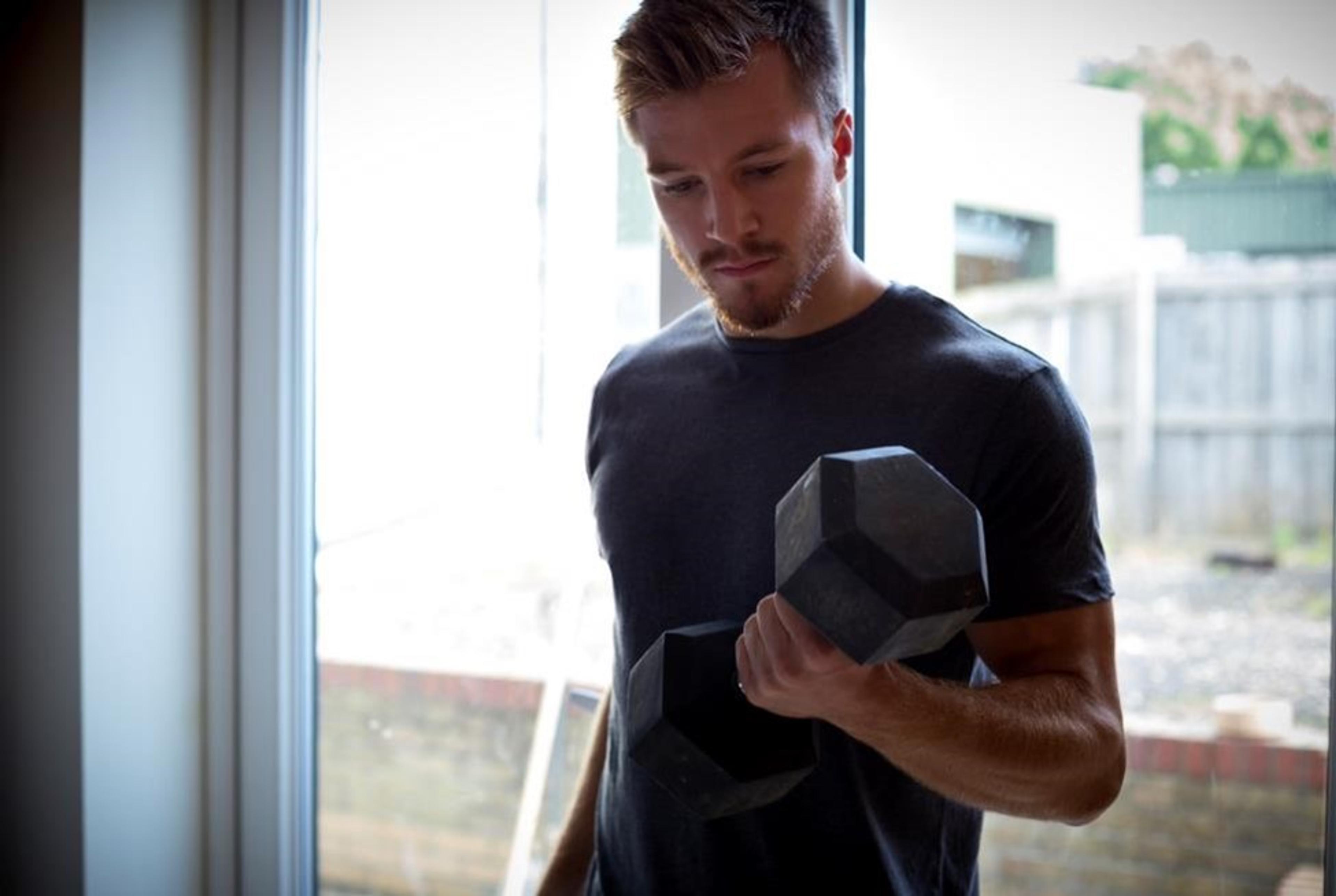 A man lifting weights at home