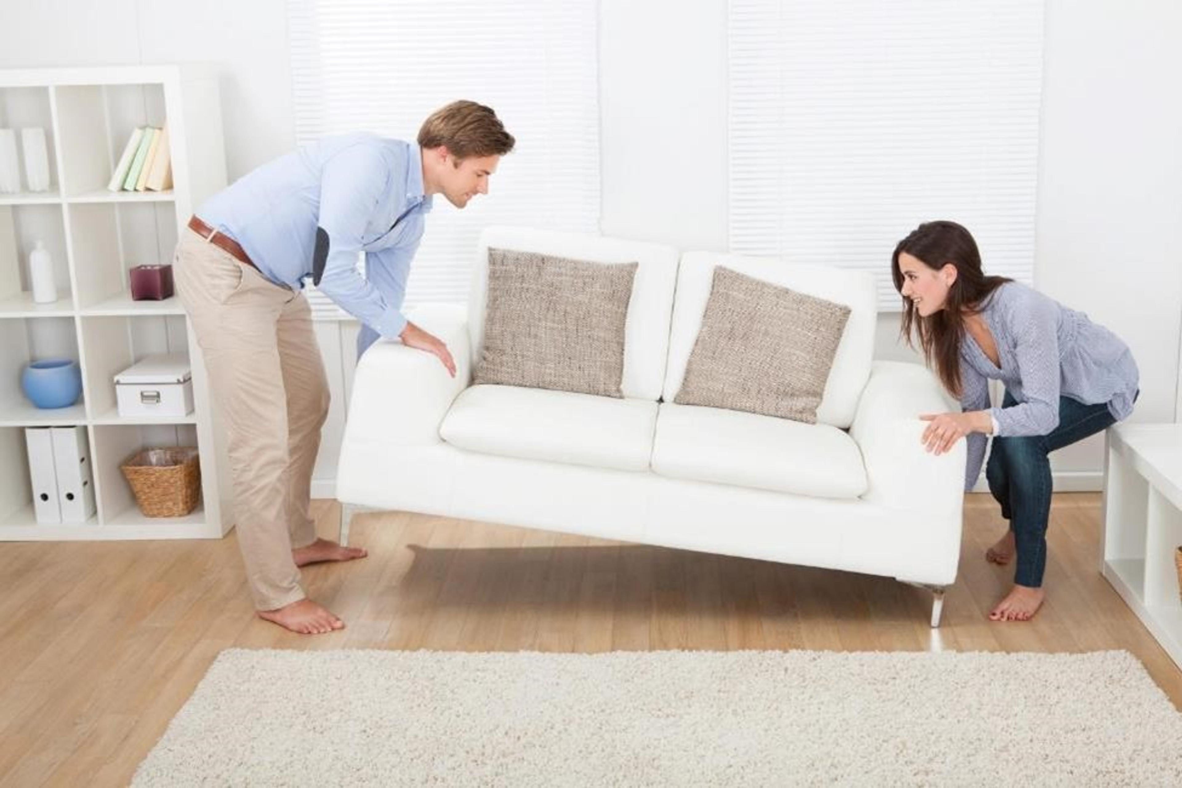 A couple moving a couch