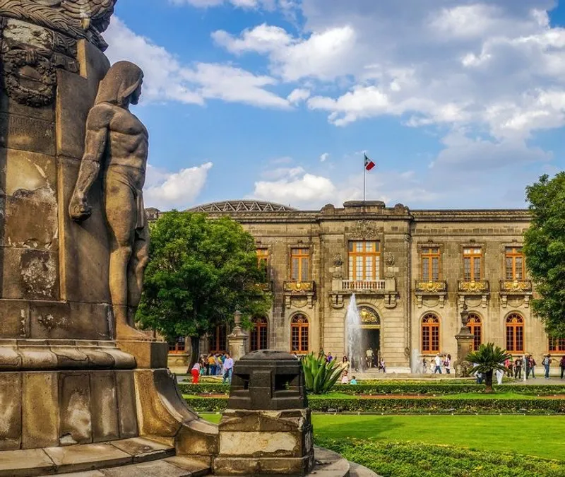 Stone building with fountain and statue in Chapultepec Forest, sunny day