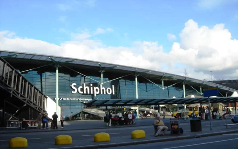 Ansicht eines großen Gebäudes mit einem Schild, das auf den Flughafen Amsterdam hinweist