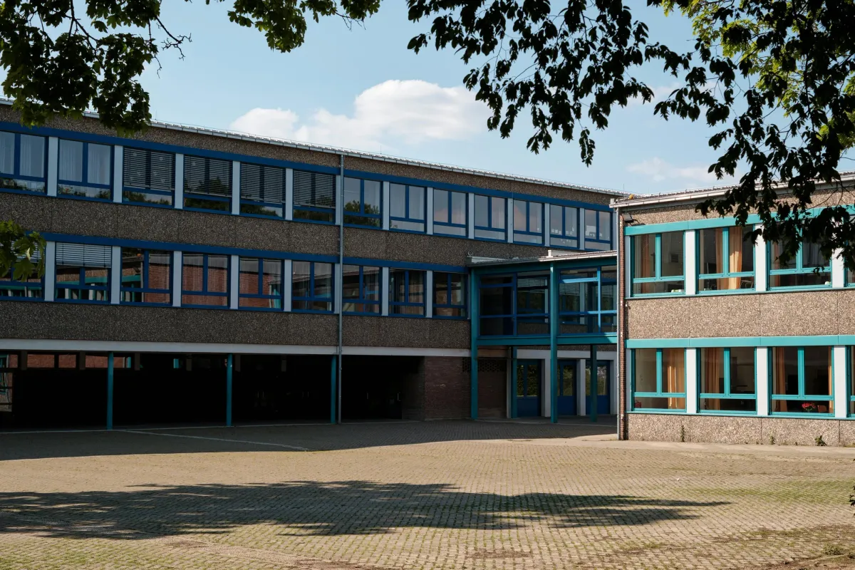 The exterior of a modern multi-story school building
