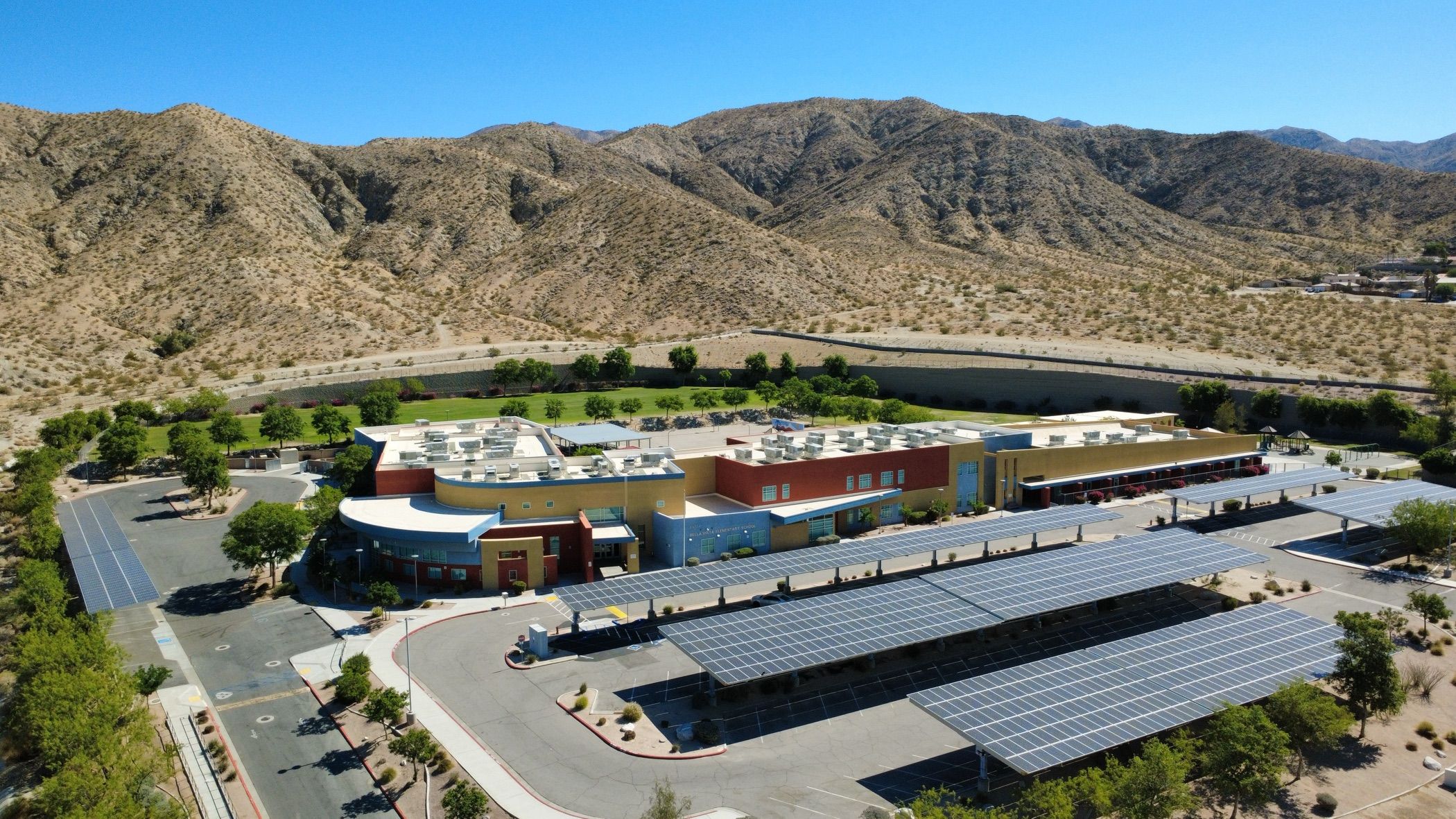 Aerial view of a football stadium and track at a Palm Springs Unified School District campus in Palm Springs, California