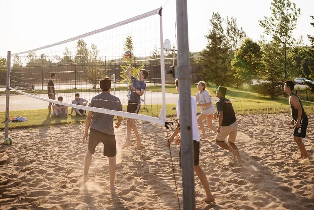 Group playing volleyball outdoors