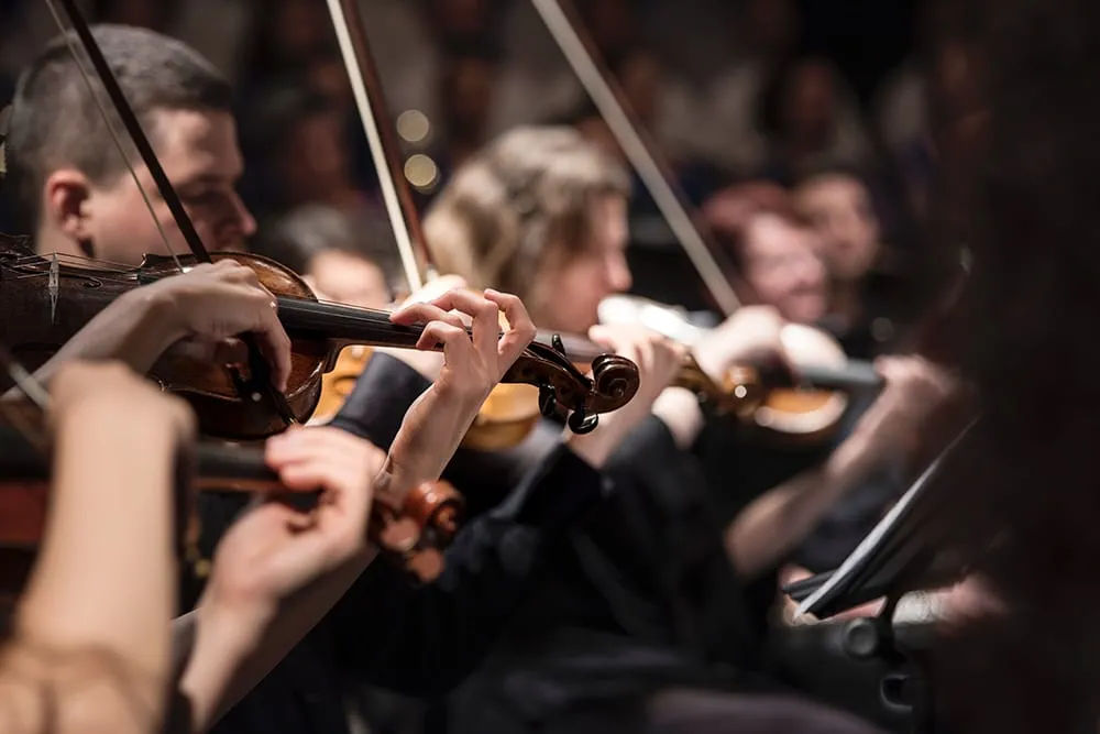 Musicians performing on a theater stage