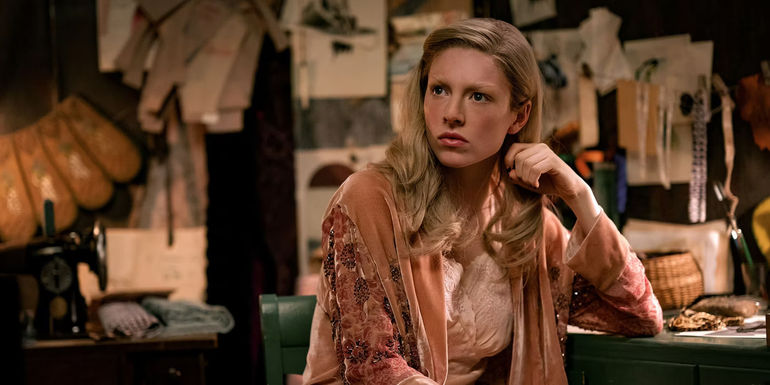 Hunter Schafer as Tigris Snow at a desk of sketches in The Hunger Games: The Ballad of Songbirds and Snakes