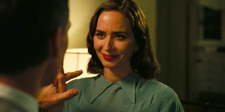 Katherine (Emily Blunt) smiling at J. Robert Oppenheimer (Cillian Murphy) in Oppenheimer
