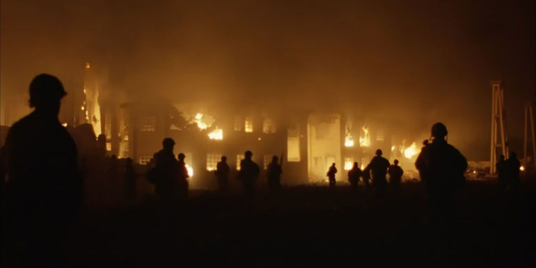 Soldiers walking through a burning village in Full Metal Jacket