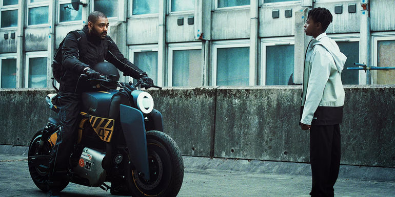 The Kitchen Izi on a motorcycle in front of Benji