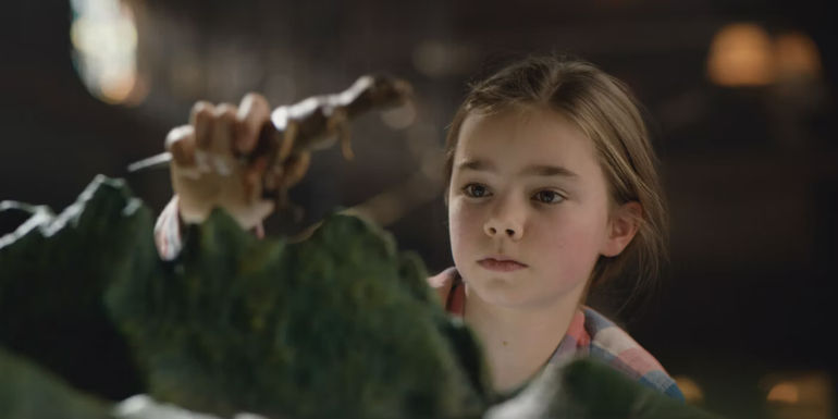 Maisie plays with a toy dinosaur in Jurassic World Fallen Kingdom