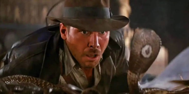 Indiana Jones faces off against a snake in Raiders of the Lost Ark