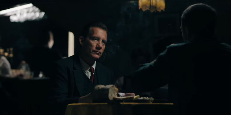 Clive Owen as Sam Spade in tense conversation in Monsieur Spade