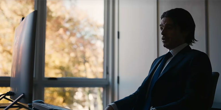 Vlad Tenev sits at a computer in Dumb Money.