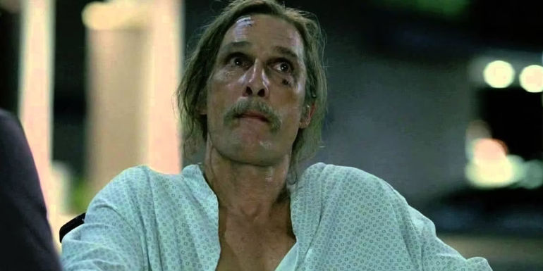 Matthew McConaughey as Rust Cohle with long hair and mustache, wearing a hospital gown, in True Detective season 1