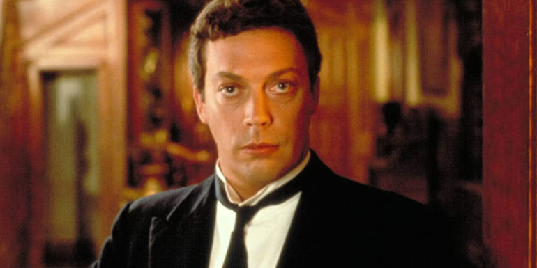 Tim Curry as Wadsworth, standing in the doorway and looking intense in Clue