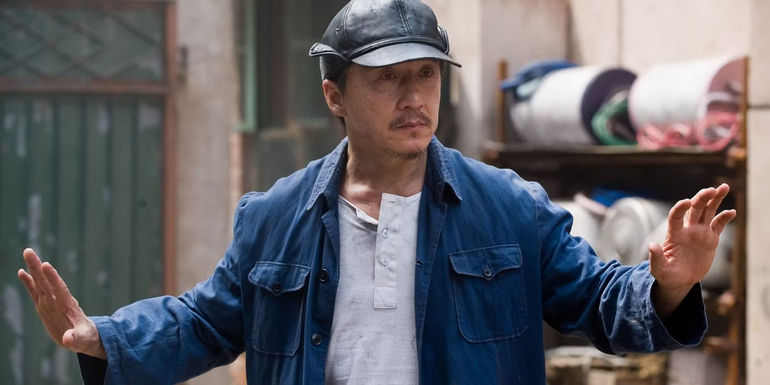 Jackie Chan holding his hands up in Karate Kid