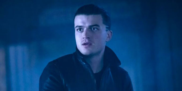 Joe Keery as Gator Tillman looking surprised in a dark room in Fargo season 5