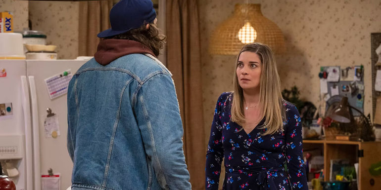 Allison looking in shock at Neil standing with his back to the image on Kevin Can F**k Himself.