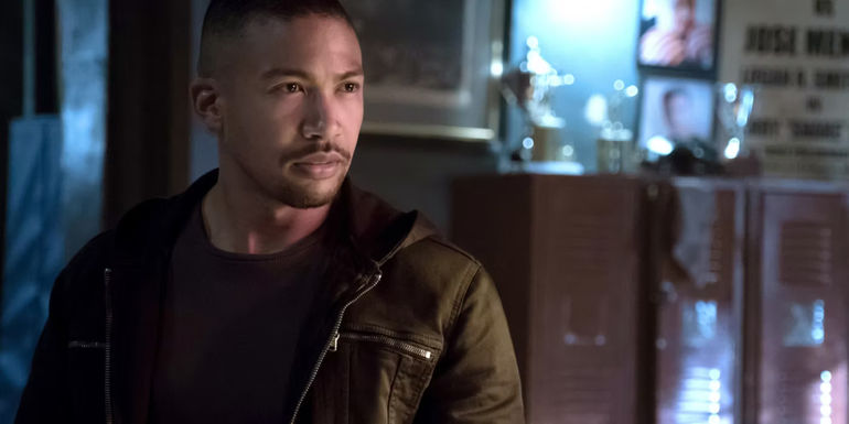 Marcel in a black jacket talking to someone in The Originals