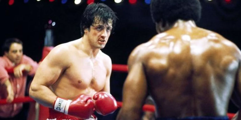 Sylvester Stallone as Rocky squares up to fight Carl Weathers' Apollo Creed in Rocky.