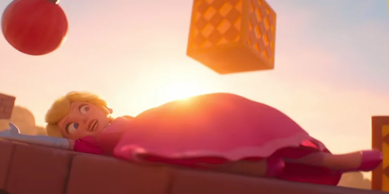 Peach slides under an obstacle in The Super Mario Bros. Movie.